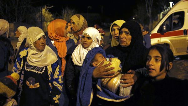 In this Monday, Jan. 11, 2016 photo, people wait to leave the besieged town of Madaya, northwest of Damascus, Syria. Aid convoys reached three besieged villages on Monday — Madaya, near Damascus, where about 400 people need to be evacuated immediately to receive life-saving treatment for medical conditions, malnourishment and starvation, and the Shiite villages of Foua and Kfarya in northern Syria - Sputnik International