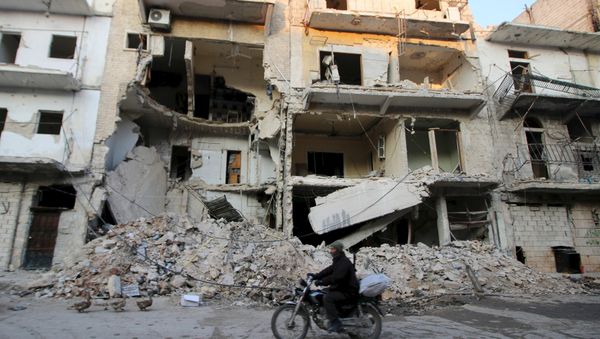 A man rides a motorcycle past damaged buildings in al-Myassar neighborhood of Aleppo, Syria January 31, 2016 - Sputnik International