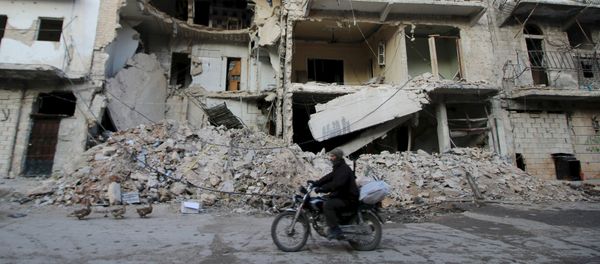A man rides a motorcycle past damaged buildings in al-Myassar neighborhood of Aleppo, Syria January 31, 2016 A man rides a motorcycle past damaged buildings in al-Myassar neighborhood of Aleppo, Syria January 31, 2016 - Sputnik International