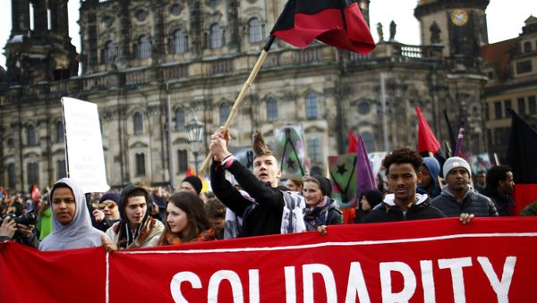 Opponents of the anti-Islam movement Patriotic Europeans Against the Islamisation of the West (PEGIDA) take part in a demonstration in Dresden, Germany - Sputnik International