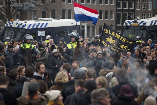 A flag reads Islamists Not Welcome as mounted Dutch riot police separates pro and anti Pegida demonstrators during a rally against islamisation in Amsterdam, Netherlands - Sputnik International
