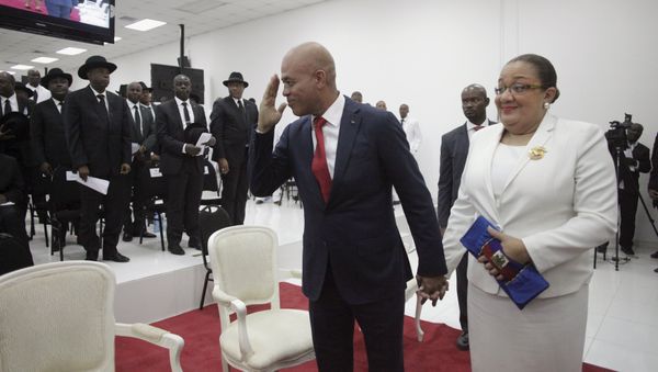 Haiti's former President Michel Martelly says goodbye as he accompanied by his wife Sophia at the end of a ceremony marking the end of his presidential term in the Haitian Parliament in Port-au-Prince, Haiti, February 7, 2016 Haiti's former President Michel Martelly says goodbye as he accompanied by his wife Sophia at the end of a ceremony marking the end of his presidential term in the Haitian Parliament in Port-au-Prince, Haiti, February 7, 2016 - Sputnik International