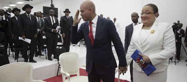 Haiti's former President Michel Martelly says goodbye as he accompanied by his wife Sophia at the end of a ceremony marking the end of his presidential term in the Haitian Parliament in Port-au-Prince, Haiti, February 7, 2016 Haiti's former President Michel Martelly says goodbye as he accompanied by his wife Sophia at the end of a ceremony marking the end of his presidential term in the Haitian Parliament in Port-au-Prince, Haiti, February 7, 2016 - Sputnik International