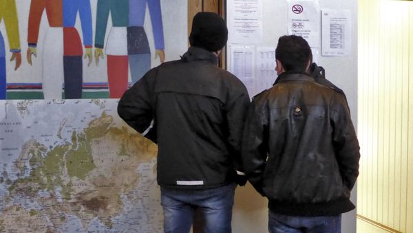 Men look at a notice board at a reception center for Syrian asylum-seekers in Naerboe, Norway, January 19, 2016. Men look at a notice board at a reception center for Syrian asylum-seekers in Naerboe, Norway, January 19, 2016. - Sputnik International