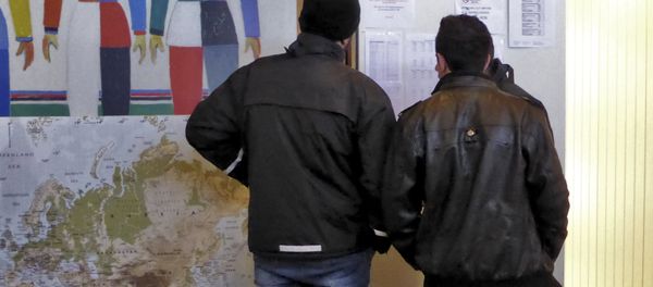 Men look at a notice board at a reception center for Syrian asylum-seekers in Naerboe, Norway, January 19, 2016. Men look at a notice board at a reception center for Syrian asylum-seekers in Naerboe, Norway, January 19, 2016. - Sputnik International