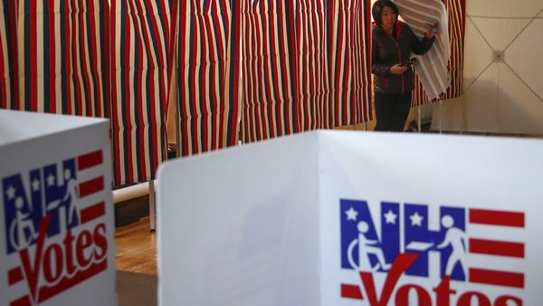 A woman looks to cast her ballot after voting in New Hampshire's first-in-the-nation primary in Bethelehem Town Hall, New Hampshire - Sputnik International
