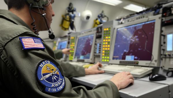 A controller monitors is seen screening aboard a NATO AWACS (Airborne Warning and Control Systems) aircraft during a surveillance flight over Romania in this April 16, 2014. - Sputnik International