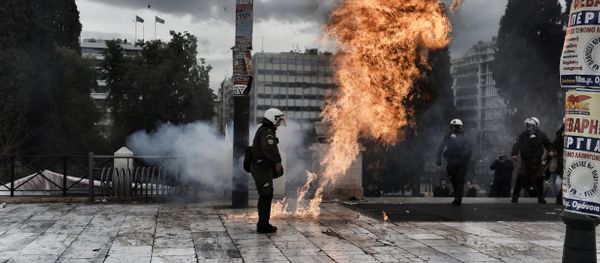 A firebomb explodes beside a riot police member during a massive protest in Athens on February 4, 2016. A firebomb explodes beside a riot police member during a massive protest in Athens on February 4, 2016. - Sputnik International