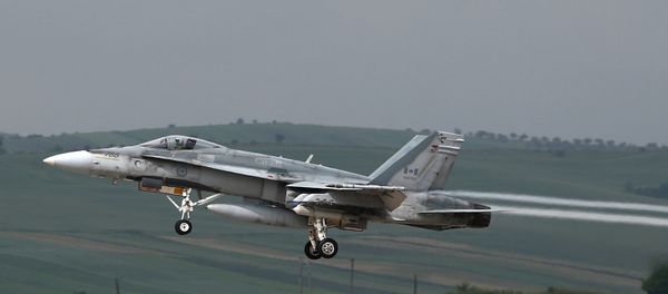 This file photo taken on May 28, 2014 shows a fighter type F-18 Hornet of the Canadian Royal Air Force taking off from the military airbase at Campia Turzii. Canada will end air strikes targeting the Islamic State group in Iraq and Syria and bring home its six fighter jets on February 22, the government announced February 8, 2016 - Sputnik International