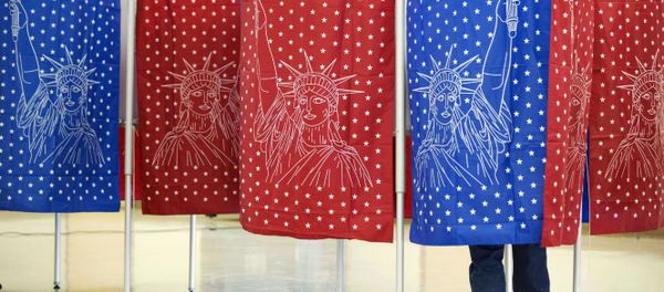 A voter marks a ballot for the New Hampshire primary inside a voting booth. A voter marks a ballot for the New Hampshire primary inside a voting booth. - Sputnik International