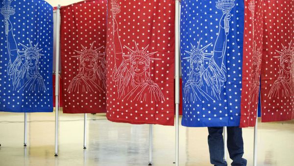 A voter marks a ballot for the New Hampshire primary inside a voting booth. - Sputnik International