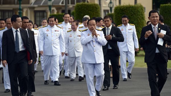 Thailand's deputy prime minister and defence minister General Prawit Wongsuwan (C) makes a traditional greeting as he arrives for a cabinet group picture following a reshuffle on August 20 to include 10 new ministers, at Government House in Bangkok on August 25, 2015 Thailand's deputy prime minister and defence minister General Prawit Wongsuwan (C) makes a traditional greeting as he arrives for a cabinet group picture following a reshuffle on August 20 to include 10 new ministers, at Government House in Bangkok on August 25, 2015 - Sputnik International