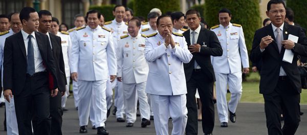 Thailand's deputy prime minister and defence minister General Prawit Wongsuwan (C) makes a traditional greeting as he arrives for a cabinet group picture following a reshuffle on August 20 to include 10 new ministers, at Government House in Bangkok on August 25, 2015 - Sputnik International