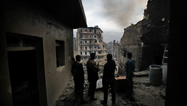 Kurdish military unit fighting along side rebel fighters, monitor the area in the besieged district of Karmel al-Jabl in eastern Aleppo - Sputnik International