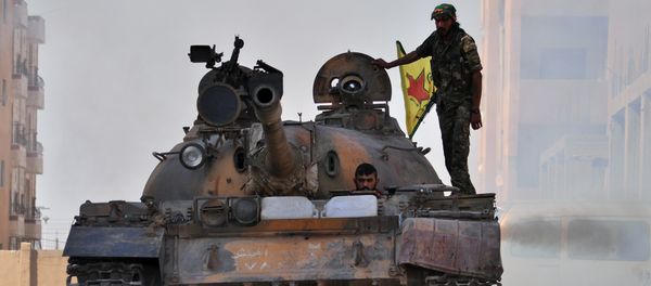 Fighters from the Kurdish People's Protection Units (YPG) drive a tank in the al-Zohour neighbourhood of northeastern Syrian city of Hasakeh (File) - Sputnik International