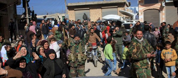Residents of Nubul and al-Zahraa, along with forces loyal to Syria's President Bashar al-Assad, celebrate after the siege of their towns was broken, northern Aleppo countryside, Syria, in this handout picture provided by SANA on February 4, 2016 - Sputnik International