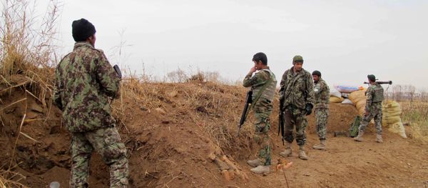 Afghan National Army (ANA) soldiers stand guard during an operation against Taliban militants in the Nad Ali district of Helmand on December 26, 2015 - Sputnik International
