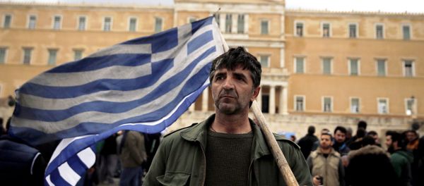 A farmer carries a Greek flag in front of the parliament during a protest against planned pension reforms in Athens, Greece February 12, 2016. A farmer carries a Greek flag in front of the parliament during a protest against planned pension reforms in Athens, Greece February 12, 2016. - Sputnik International