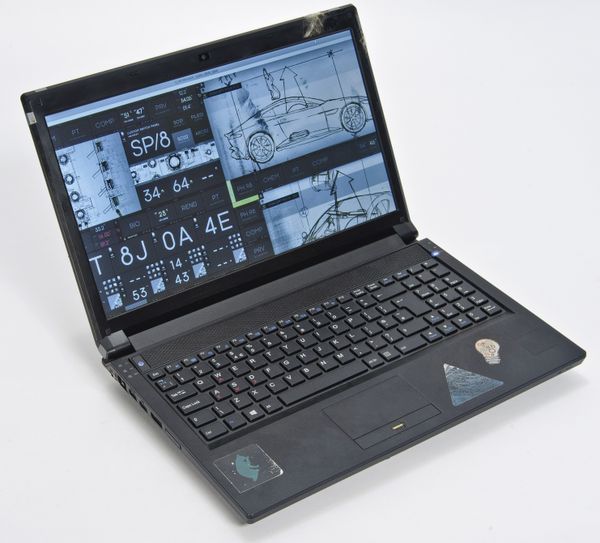 Q’s personalized laptop used by Ben Whishaw. A Clevo laptop (model: P151SM1) dressed with stickers and tape to reflect Q’s character. - Sputnik International