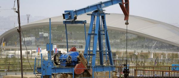 The Baku Aquatics Centre, one of the venues of the 2015 European Games stands in the background, as an oil pump works a nearby field in Baku, Azerbaijan. The Baku Aquatics Centre, one of the venues of the 2015 European Games stands in the background, as an oil pump works a nearby field in Baku, Azerbaijan. - Sputnik International