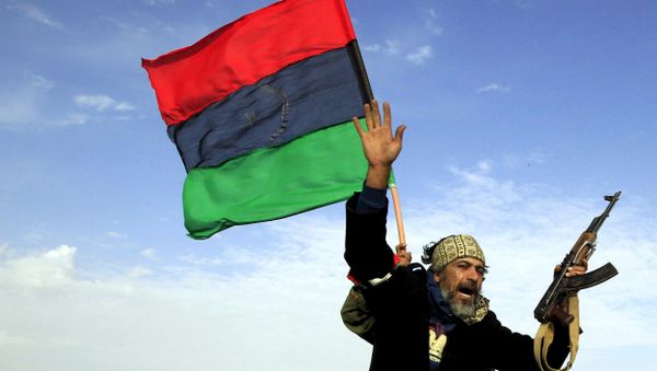 A rebel soldier gestures atop a car as he heads to Brega, in Ajdabiya March 2, 2011. - Sputnik International