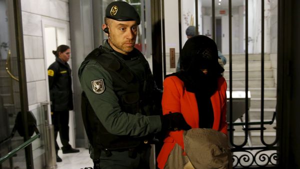 A suspect is led by a Spanish Civil Guard officer as they leave the headquarters of Industrial and Commercial Bank of China (ICBC) during a raid in Madrid, Spain, February 17, 2016 - Sputnik International