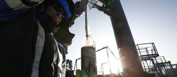 A worker takes oil samples from a well at the Gazpromneft company owned Yuzhno-Priobskoye oil field outside the West Siberian city of Khanty-Mansiysk, Russia, January 28, 2016 A worker takes oil samples from a well at the Gazpromneft company owned Yuzhno-Priobskoye oil field outside the West Siberian city of Khanty-Mansiysk, Russia, January 28, 2016 - Sputnik International