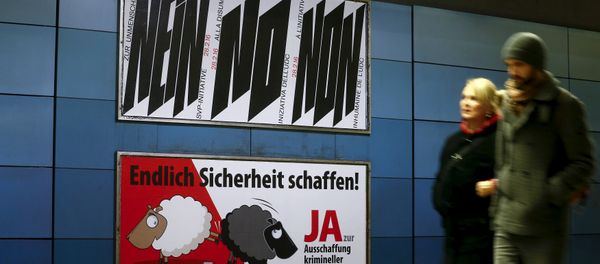 A poster of Swiss People's Party (SVP), demanding to vote for an initiative to deport criminal foreigners, is placed underneath another one against it at the central railway station in Zurich, Switzerland February 12, 2016 - Sputnik International