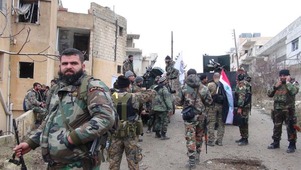 Forces loyal to the Syrian regime stand on a street with national flags after Syria's army and allied forces took full control from rebel groups of the strategic town of Salma, in the northwestern province of Latakia on January 12, 2016 Forces loyal to the Syrian regime stand on a street with national flags after Syria's army and allied forces took full control from rebel groups of the strategic town of Salma, in the northwestern province of Latakia on January 12, 2016 - Sputnik International