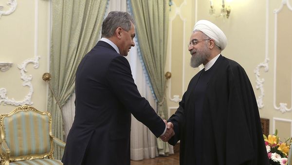President Hassan Rouhani, right, shakes hands with Russian Defence Minister Sergei Shoigu at the start of their meeting in Tehran, Iran President Hassan Rouhani, right, shakes hands with Russian Defence Minister Sergei Shoigu at the start of their meeting in Tehran, Iran - Sputnik International