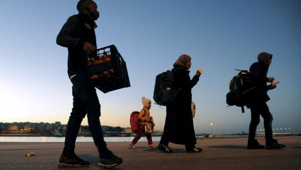 Refugees and migrants walk after disembarking from passenger ferry Blue Star1 at the port of Piraeus, near Athens, Greece, February 20, 2016. Refugees and migrants walk after disembarking from passenger ferry Blue Star1 at the port of Piraeus, near Athens, Greece, February 20, 2016. - Sputnik International