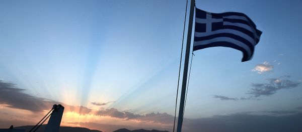 A man watches the sunrise from a ferry near the port of Piraeus on April 23, 2014. A man watches the sunrise from a ferry near the port of Piraeus on April 23, 2014. - Sputnik International