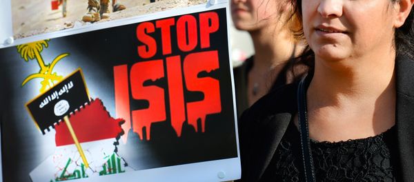 A holds a sign calling to Stop ISIS (ISIS fir Islamic State) on August 13, 2014 as she takes part in a demonstration called by Kurds in support of the Yezidis and the Christians in Iraq, in Arnhem, The Netherlands. A holds a sign calling to Stop ISIS (ISIS fir Islamic State) on August 13, 2014 as she takes part in a demonstration called by Kurds in support of the Yezidis and the Christians in Iraq, in Arnhem, The Netherlands. - Sputnik International