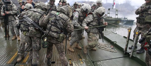 U.S. and South Korean, left, army soldiers work together to set up a floating bridge on the Hantan river during a river crossing operation, part of an annual joint military exercise between South Korea and the United States U.S. and South Korean, left, army soldiers work together to set up a floating bridge on the Hantan river during a river crossing operation, part of an annual joint military exercise between South Korea and the United States - Sputnik International