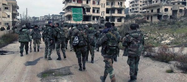 In this photo released on Tuesday, Jan 12, 2016, by the Syrian official news agency SANA, shows Syrian government troops and allied militiamen walk inside the key town of Salma in Latakia province, Syria In this photo released on Tuesday, Jan 12, 2016, by the Syrian official news agency SANA, shows Syrian government troops and allied militiamen walk inside the key town of Salma in Latakia province, Syria - Sputnik International