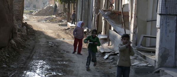 Syrian children play between buildings destroyed by shelling in the neighbourhood of Jobar, on the eastern outskirts of the capital Damascus, on February 24, 2016 Syrian children play between buildings destroyed by shelling in the neighbourhood of Jobar, on the eastern outskirts of the capital Damascus, on February 24, 2016 - Sputnik International