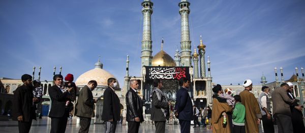 Iranians hold their identification cards as they line up outside a polling station at Massoumeh shrine during the parliamentary and Assembly of Experts elections at a polling station in the holy city of Qom, 130kms south of the capital Tehran, on February 26, 2016 Iranians hold their identification cards as they line up outside a polling station at Massoumeh shrine during the parliamentary and Assembly of Experts elections at a polling station in the holy city of Qom, 130kms south of the capital Tehran, on February 26, 2016 - Sputnik International