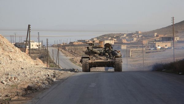 Syrian government forces drive a tank on a road during a military operation against Daesh in the villages of Zarour and Khanaser, in the Aleppo province, on February 26, 2016 Syrian government forces drive a tank on a road during a military operation against Daesh in the villages of Zarour and Khanaser, in the Aleppo province, on February 26, 2016 - Sputnik International