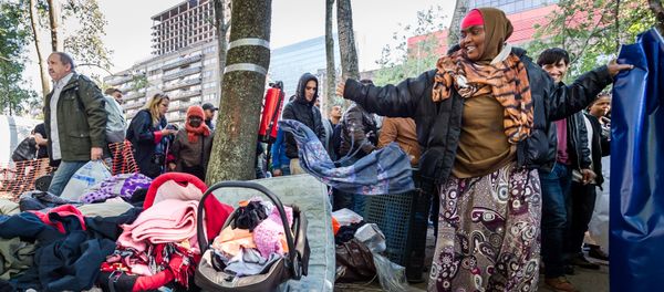Refugees leave a tent camp for refugees in Brussels on Thursday, Oct. 1, 2015 Refugees leave a tent camp for refugees in Brussels on Thursday, Oct. 1, 2015 - Sputnik International