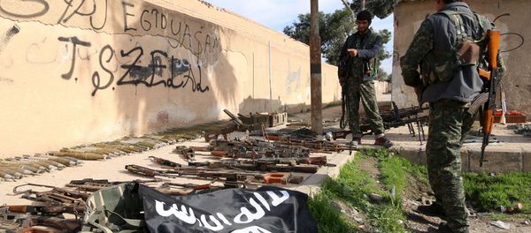 Fighters from the Democratic Forces of Syria inspect weapons and ammunition that, according to them, belonged to Islamic State fighters, in al-Shadadi town, in Hasaka province, Syria February 26, 2016 - Sputnik International