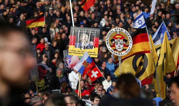 Supporters of the anti-Islam movement Patriotic Europeans Against the Islamisation of the West (Pegida) hold posters depicting German Chancellor Angela Merkel during a demonstration in Dresden, Germany, February 6, 2016 Supporters of the anti-Islam movement Patriotic Europeans Against the Islamisation of the West (Pegida) hold posters depicting German Chancellor Angela Merkel during a demonstration in Dresden, Germany, February 6, 2016 - Sputnik International