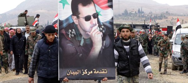 Syrian volunteers and their relatives wave the national flag and portraits of President Bashar al-Assad as they celebrate at the end of a paramilitary training conducted by the Syrian army in al-Qtaifeh, 50 kms north of the capital Damascus on February 22, 2016 - Sputnik International