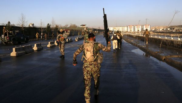 An Afghan security forces holds up his rifle as he walks at the site of an attack in Kabul, Afghanistan February 27, 2016 - Sputnik International