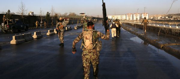 An Afghan security forces holds up his rifle as he walks at the site of an attack in Kabul, Afghanistan February 27, 2016 - Sputnik International