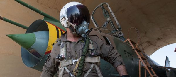 A Syrian pilot prepares for a flight at the Syrian Air Force base in Homs province A Syrian pilot prepares for a flight at the Syrian Air Force base in Homs province - Sputnik International