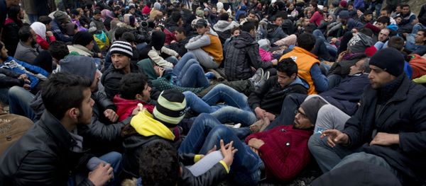 Protesting refugees and migrants block the railway tracks at the Greek-Macedonia border near the northern Greek village of Idomeni, the Sunday, Feb. 28, 2016 - Sputnik International