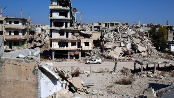 In this picture taken Friday, Feb. 26, 2016, a car drives through a devastated part of the old city of Homs, Syria In this picture taken Friday, Feb. 26, 2016, a car drives through a devastated part of the old city of Homs, Syria - Sputnik International