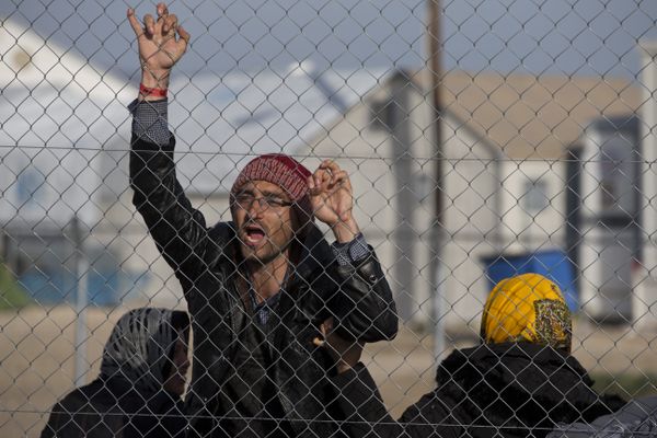 Afghan migrant shouts Merkel help us in the northern Greek border station of Idomeni , Tuesday, Feb. 23, 2016 Afghan migrant shouts Merkel help us in the northern Greek border station of Idomeni , Tuesday, Feb. 23, 2016 - Sputnik International