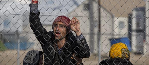Afghan migrant shouts Merkel help us in the northern Greek border station of Idomeni , Tuesday, Feb. 23, 2016 Afghan migrant shouts Merkel help us in the northern Greek border station of Idomeni , Tuesday, Feb. 23, 2016 - Sputnik International