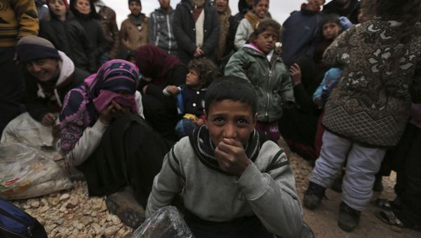 Syrians gather at the Bab al-Salam border gate with Turkey, in Syria, Saturday, Feb. 6, 2016 - Sputnik International